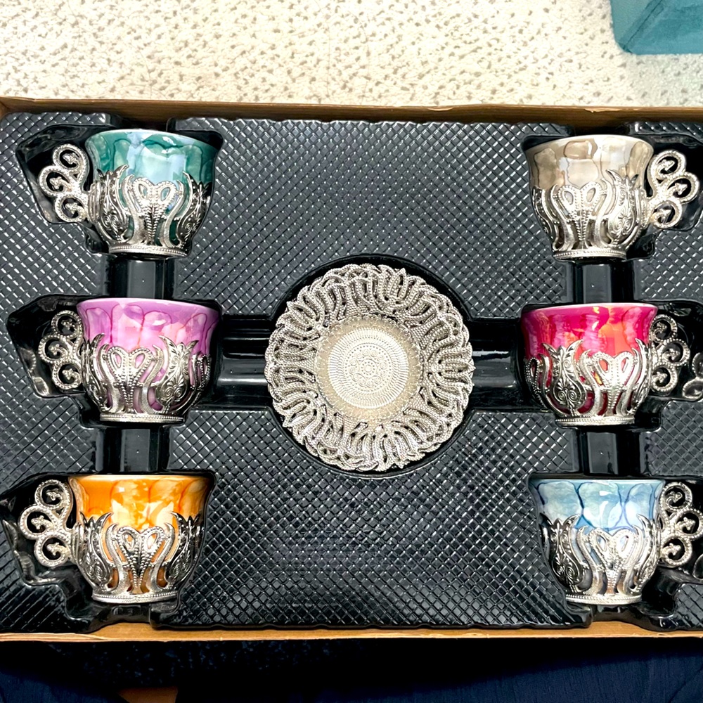 Colorful Turkish tea set with silver cup holders and saucers